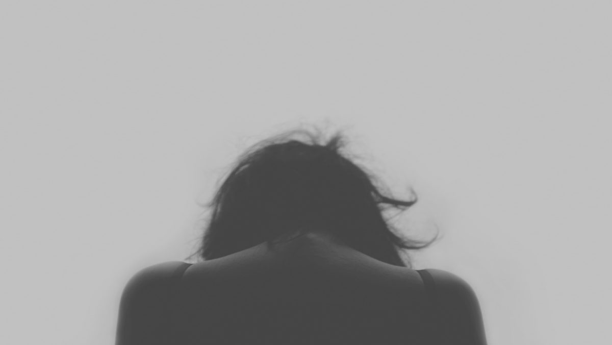 Representative image of a silhouette of a woman with her head bowed