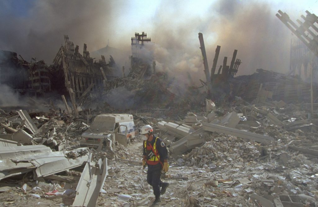 An emergency worker walks amid the rubble of the World Trade Center in Manhattan after the September 11, 2001, attacks | Image Courtesy: FBI
