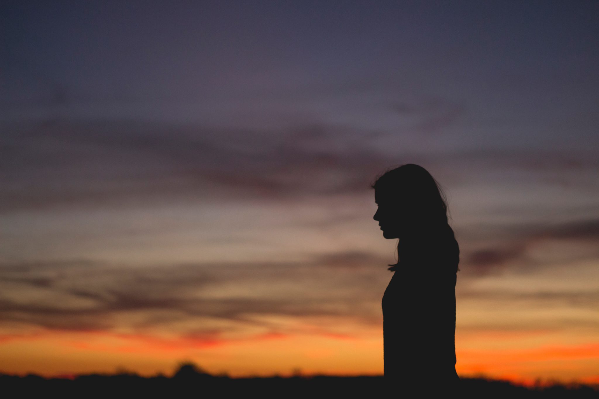 Representative image of the silhouette of a woman against a sunset
