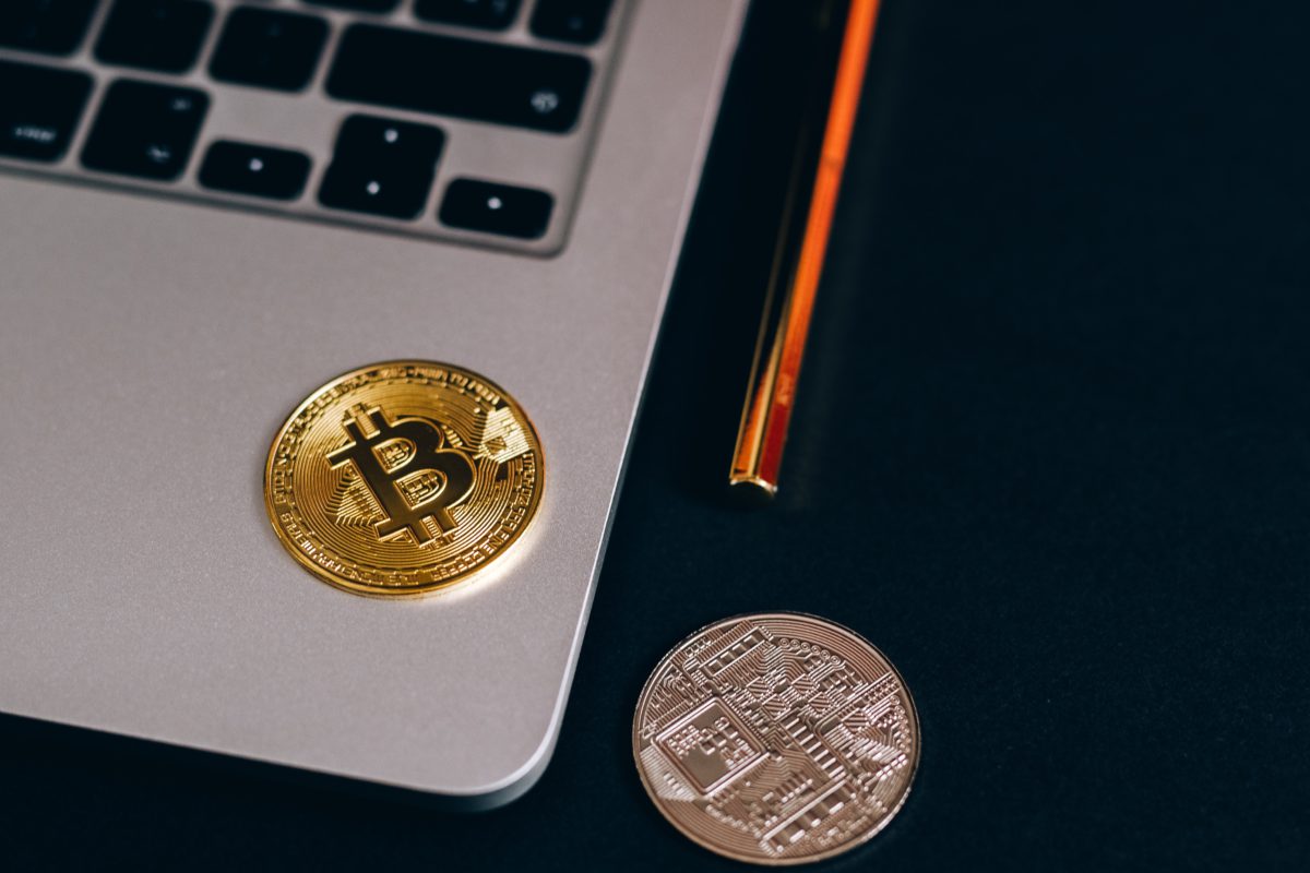 Photo of a coin with the Bitcoin symbol on it on a laptop