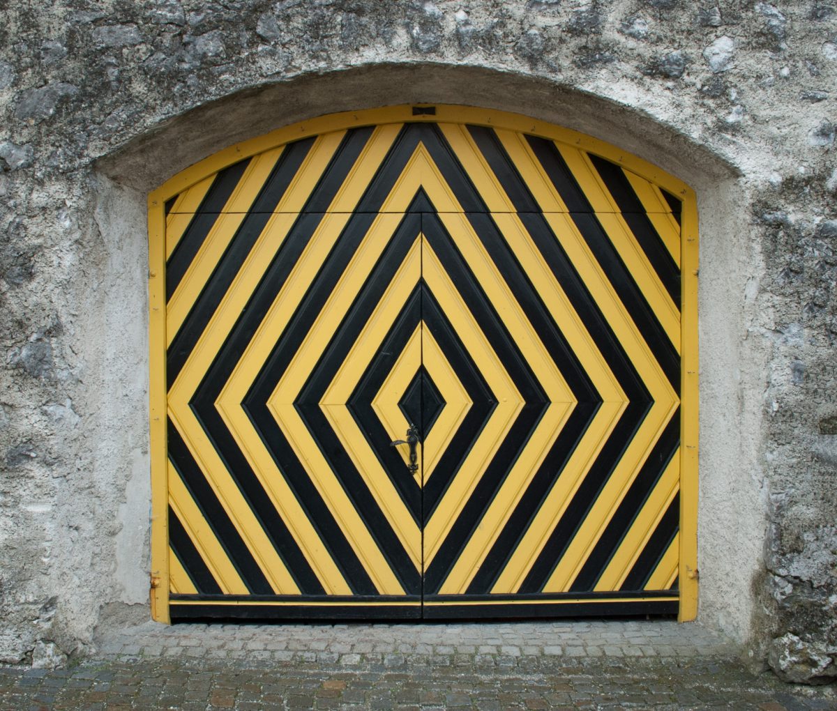 Representative photo of a door painted with the black and yellow "safety" stripes